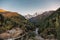 Asphalt road with cars in autumn valley with mountain