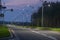 Asphalt road in the evening light, illuminated with the light of street lanterns.