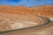 Asphalt road with extreme landscape next to the Moon valley in Atacama desert at San Pedro de Atacama, Chile.