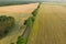 Asphalt road among fields. Photo from the drone.