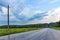 Asphalt road among the forest at sunset. Roads of Russia