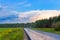 Asphalt road among the forest at sunset. Roads of Russia