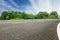 Asphalt road in front of the green woods