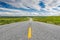 Asphalt road in green plains Norway tundra