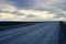 Asphalt road and heavy autumn sky