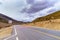 Asphalt road High way Empty curved road clouds, sky and mountain