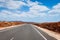 Asphalt road leading to horizon trough the dusty landscape of Boa Vista island.