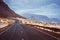 Asphalt road leads between black volcano erosion mountain and white sand dunes. Breathtaking coastline of Calhau, Sao