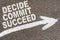 On the asphalt road markings an arrow with the inscription - DECIDE COMMIT SUCCEED