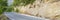 Asphalt road in the Mediterranean mountains covered with pine trees. banner.