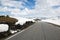 Asphalt road through the mountains with a lot of snow, summer Norway. National Tourist Route Aurlandsfjellet