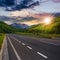 Asphalt road in mountains at sunset