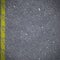 Asphalt road pavement with cracked yellow marking