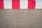 asphalt road and red, white barrier / blockade on runway on former airport -