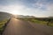 Asphalt road with reservoir on clearly blue sky and mountains.