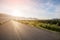 Asphalt road with reservoir on clearly blue sky and mountains.