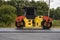 Asphalt road roller with heavy vibration roller compactor press new hot asphalt on the roadway on a road construction