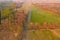 Asphalt road running through meadows and forests.