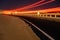 Asphalt road running through the sandy desert at night