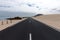 Asphalt road through sand dunes. Corralejo, Fuerteventura