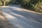 Asphalt road sharp curve along with tropical forest zigzag ahead