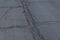 Asphalt road surface with small cracks and damages. Sidewalk asphalt road with cracks. Floor. Texture of tarmac road with cracks.