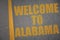 asphalt road with text welcome to alabama near yellow line