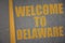 asphalt road with text welcome to delaware near yellow line