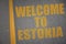 asphalt road with text welcome to estonia near yellow line.