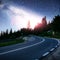 Asphalt road under a starry night sky and the Milky Way