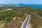 Asphalt rural road curve on high mountain with tropical sea in phuket Thailand image by Drone camera High angle view