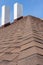 Asphalt tile roof with chimney on new home under construction