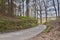 Asphalt way leading to village Karba in Machuv kraj during sping in czech landscape