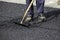 Asphalt worker legs during road renewal works