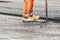 Asphalt worker with wooden clogs