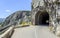 Asphalted mountain road with sharp turn near the cliff.