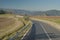 Asphalted provincial road crosses the hills of Tuscany