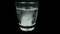 Aspirin or effervescent medical pill tablet dropped into the water on black background