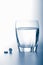 Aspirin pills and glass of water