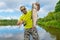 Aspius fishing. Happy fisherman with asp fish at beautifle river