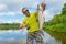 Aspius fishing. Happy fisherman with asp fish at beautifle river