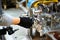 Assembling car engine by worker hand in workshop closeup