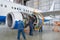 Assembling, replacing engine parts of the plane after repair. Specialist mechanic controls the crane of an airplane. Concept maint