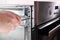 Assembly, disassembly, repair of electric oven. Worker repairs electric oven. Conveyor assembly of household appliances.Problems w