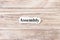 Assembly of the word on paper. concept. Words of assembly on a wooden background