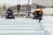 An assembly worker tries to push the ice slabs apart with a crowbar