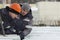 An assembly worker tries to push the ice slabs apart with a crowbar