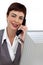 Assertive Businesswoman on phone at her desk