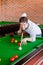 Assertive young man playing snooker