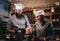 Assistant cook grinds sesame seeds in a mortar for cooking bread. Chef teaching his assistant to bake the bread in the